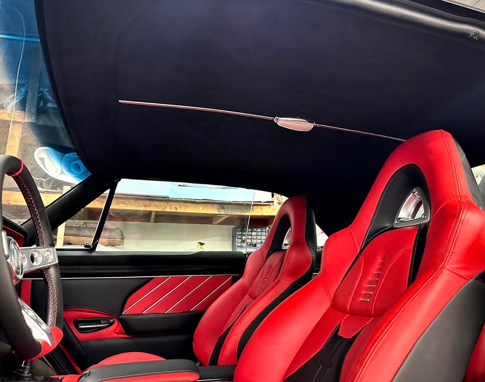 Custom red and black racing seats in a 1967 Chevelle.