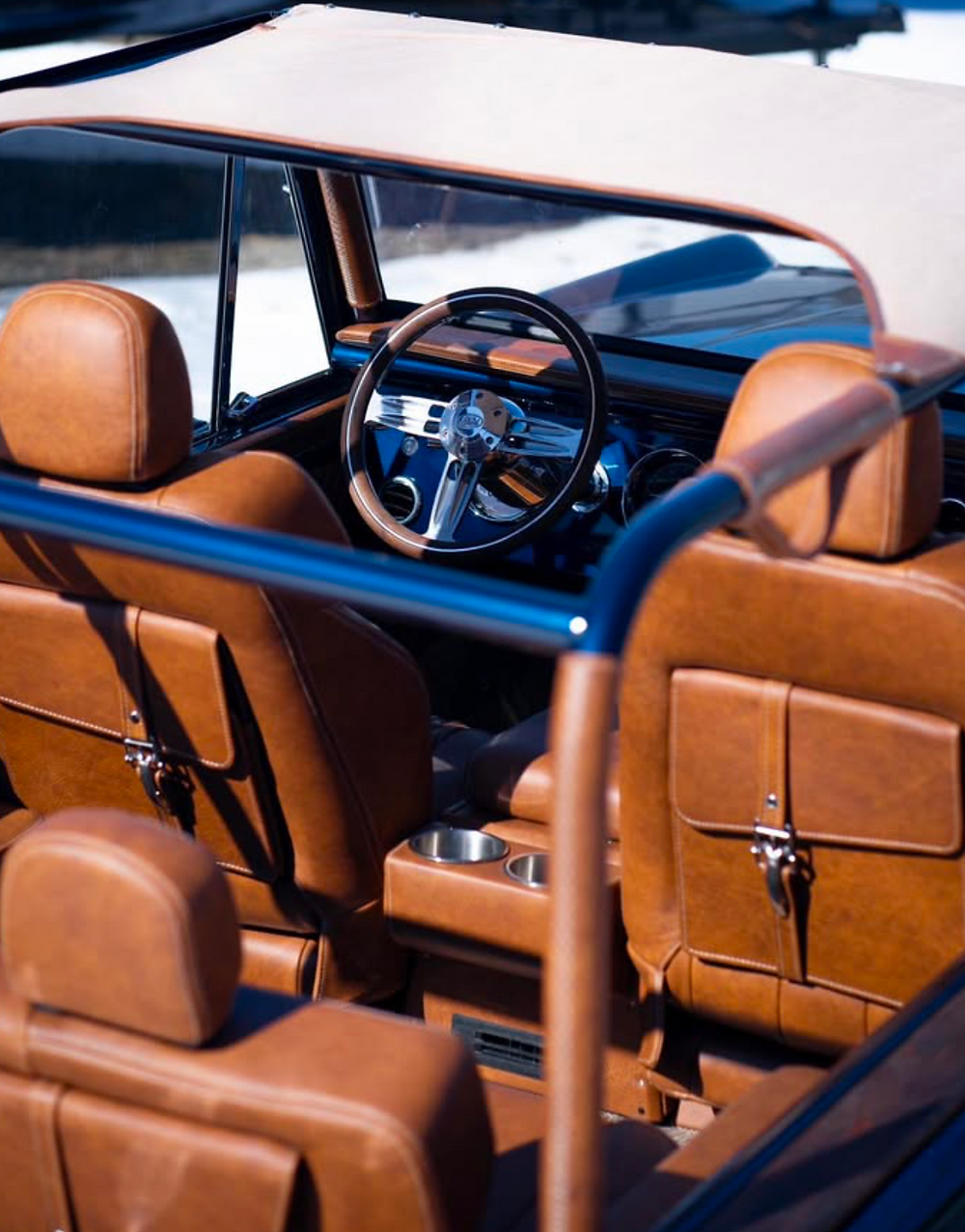 Interior of a 1977 Bronco with brown leather seats and roll bar