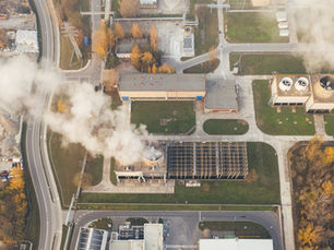 Bird's-eye-view of factories polluting the air.