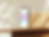 Free iPhone mockup on a wooden desk in sunlight (Mockuuups Studio)