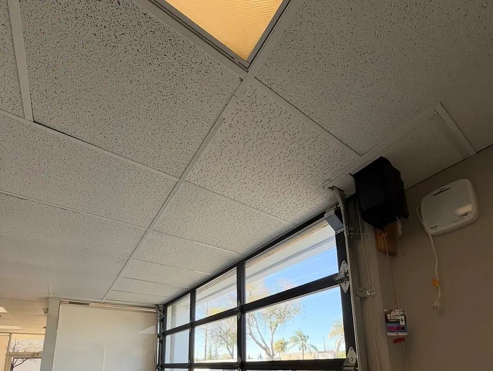 Commercial T-bar suspended ceiling repair in Granite Bay CA after tenant roll-up door installation caused drop ceiling damage and AC air leakage