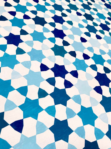 A detailed close-up of [de]formations: Serenity, highlighting the subtle transformation within the geometric pattern. The shades of blue blend seamlessly as six-pointed stars gradually morph into regular hexagons. The fine transitions between shapes become more apparent, revealing the intricate evolution of the design against the white negative space.
