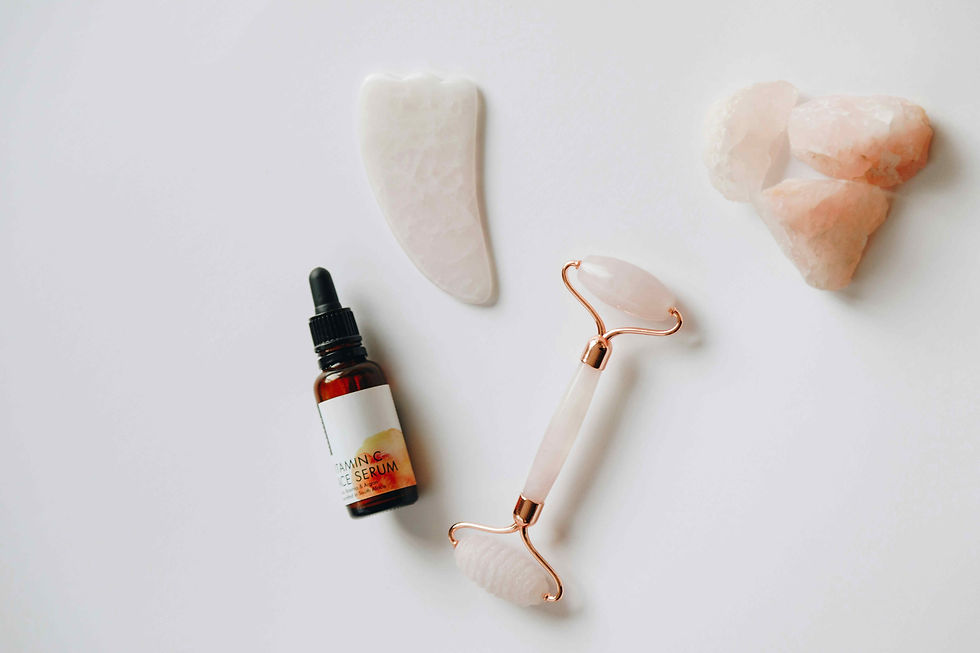 A bottle of essential oil, a smooth stone, and a colourful crystal arranged for a self-care ESL lesson.