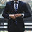 Thumbnail: A man in a suit and tie stands confidently on stairs, ready to engage in a career goals ESL collocations lesson.