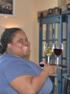 A cheerful woman serving wine