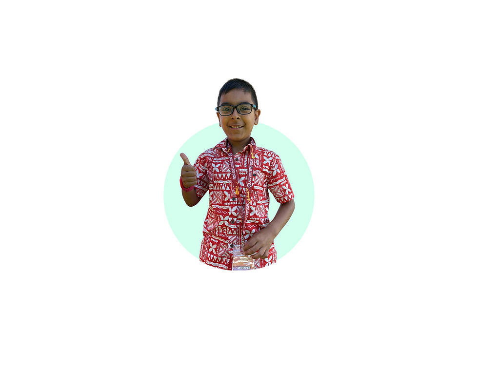 Smiling young student in a red patterned shirt giving a thumbs up at a Mechanics of Music event.