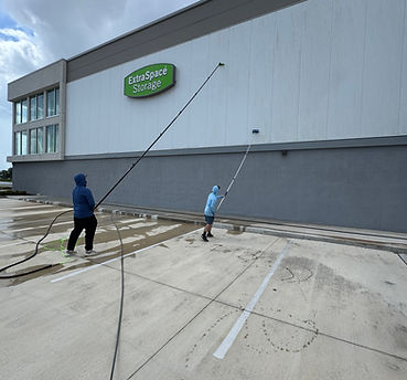 Commercial storage building being brushed by two guys