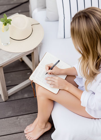 Emma Lisa, A Women's Nutritionist Sitting By The Pool With The Midlife Journal