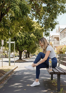 woman walking tying shoes.jpg
