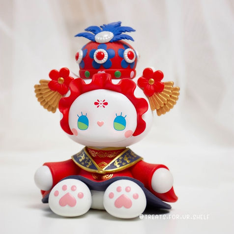 an Emma toy in a wedding outfit