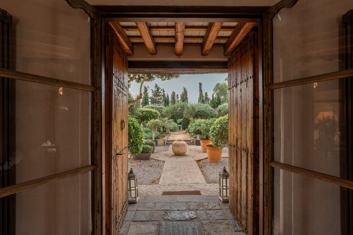 Casa La Siesta wooden arch doorway terracotta brick path garden architecture photography Vejer de la Frontera Andalucia Spain Alanoud Radaideh Anoud Radaideh