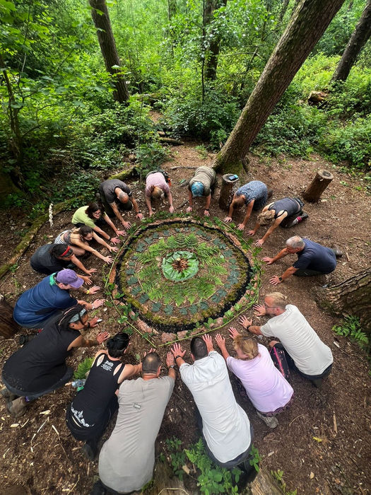 group of people round a mandala