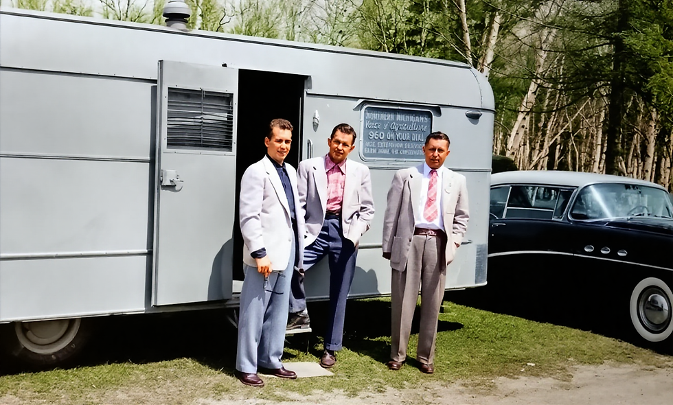 Harry Brege, Harvey Klann, and Albert Klann standing outside the trailer used for their WHAK mobile broadcasts, 1954