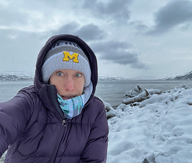 Krista Frahm, copywriter with snow/ice and a lake in the background. Making a skeptical face.