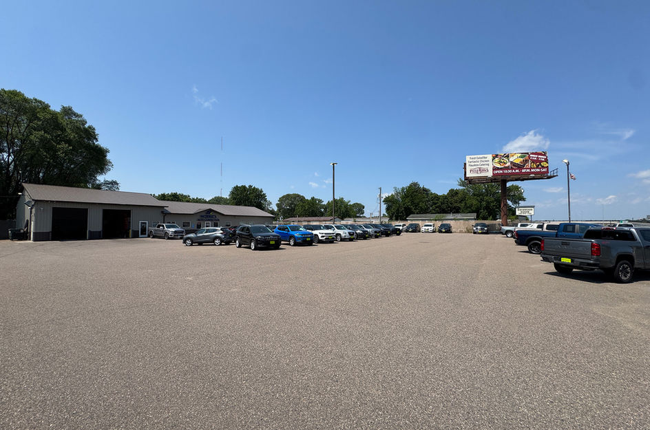 Morrie's auto dealership lot with rows of vehicles.