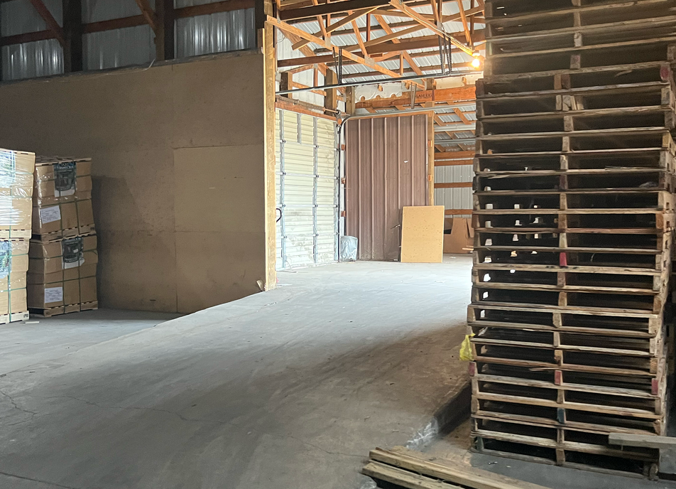 Inside of a warehouse with cross docking and palette storage.