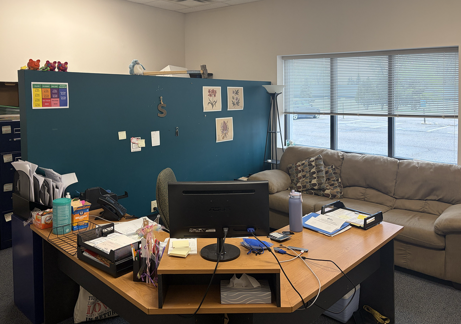 Climb Theatre office with desk, computer, and sofa.