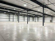 Clean warehouse interior with concrete floors and support posts