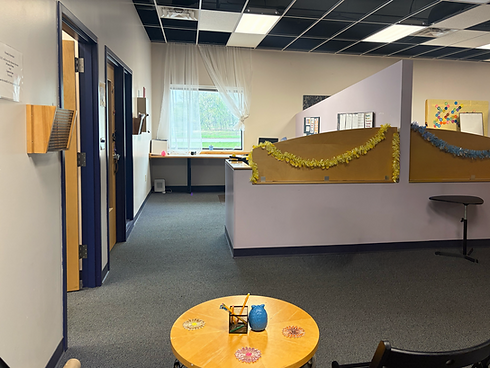 Office interior with cubicles decorated with tinsel for a cheery atmosphere.