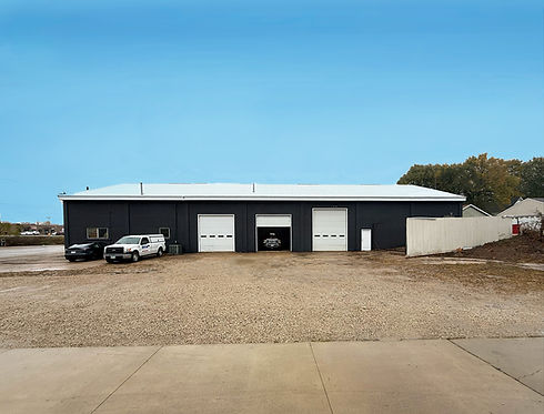 Austin Industrial exterior. Charcoal gray building with 3 drive-ins, 1 pedestrian door, and parking.
