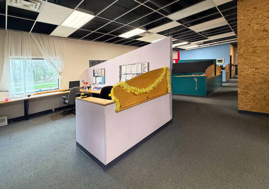 Climb Theatre office with cubicles and desks.