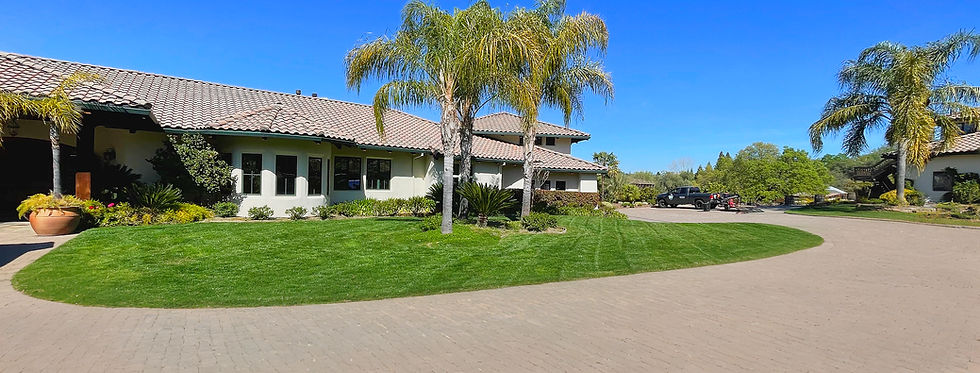 A perfectly manicured lawn with vibrant green stripes, representing the exceptional results of the Mpire Standard.
