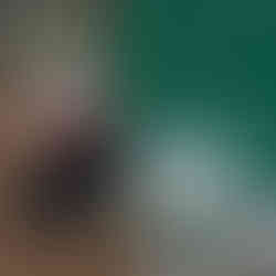 Ethan Fourie with his glass recycling collection in front of a large green drum