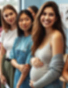 Three young women standing together in a bright room. One, pregnant, smiles warmly, cradling her belly. Casual attire, amiable mood.