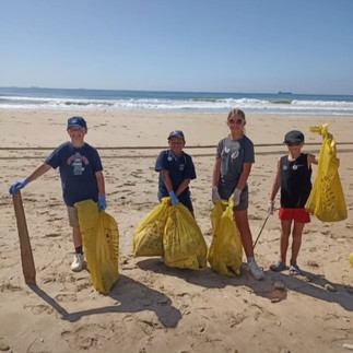 Four children taking part in a beach clean up organised by The Recycling Kid