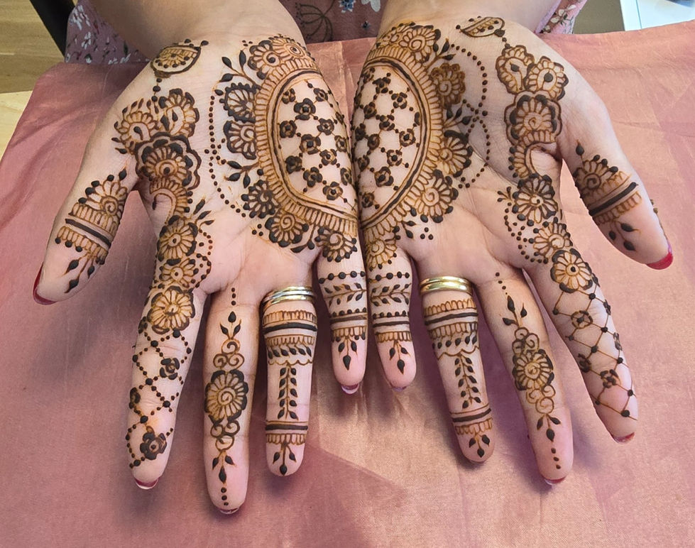 a close up of a woman 's hands with henna on them