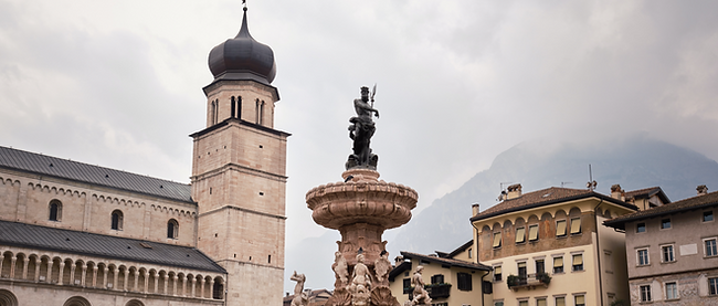 a fountain in front of a building with a clock tower in the background_edited.png