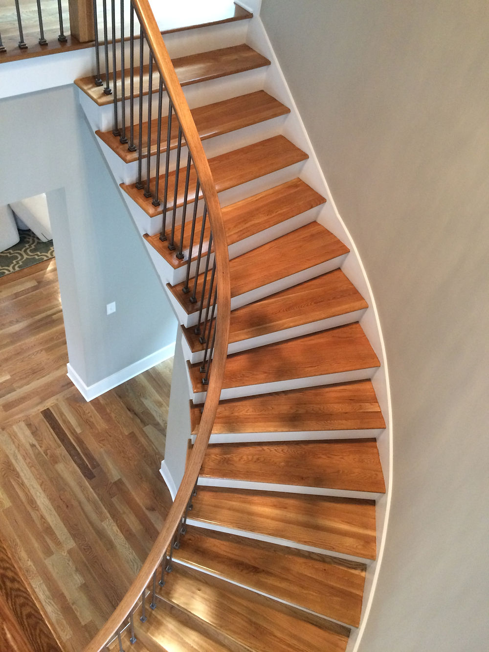 Winding hardwood staircase and floor by Charlotte's Hardwood Floor Specialists