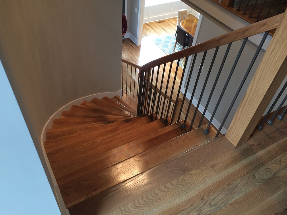 Curved hardwood staircase by Charlotte's Hardwood Floor Specialists