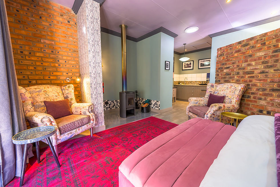 Unit 2 bedroom with fireplace and warm interior tones