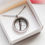 Thumbnail: A Poppy Lockets' heirloom glass locket, holding a lock of hair from a loved on. The locket is in a white PL gift box