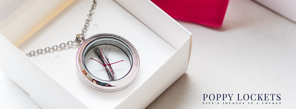 A silver locket with hair tied by maroon thread rests in a white box. Text reads "POPPY LOCKETS: LIFE'S JOURNEY IN A LOCKET."