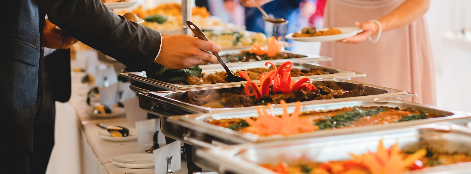 Professional catering setup with elegantly arranged dishes and drinks by Heroes Catering, Mobile Bartending & Event Planning.
