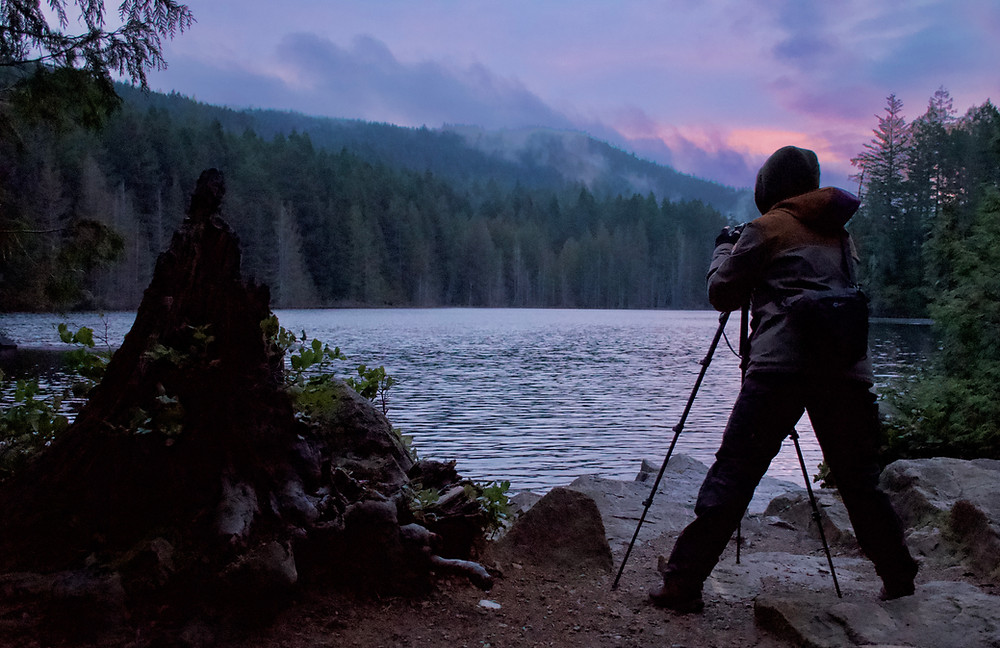 Photographer at the lake during sunrise
