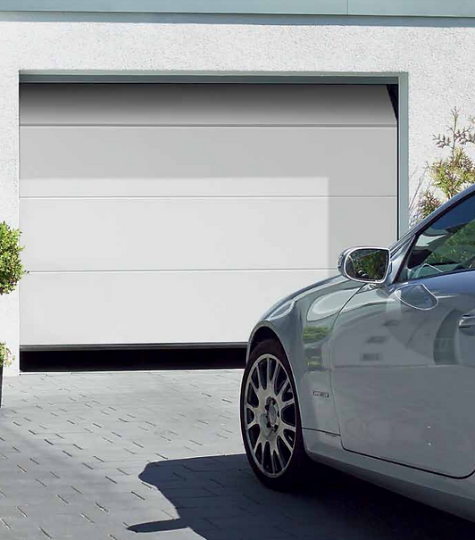 White sectional garage door with car