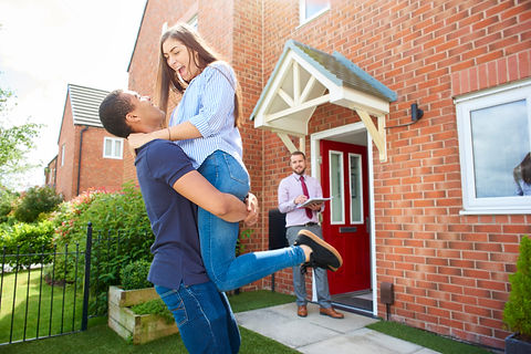 first time buyers outside a house