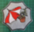 Red and white sewed badge