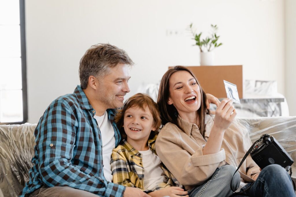 family sitting on couch - Land for sale owner financing