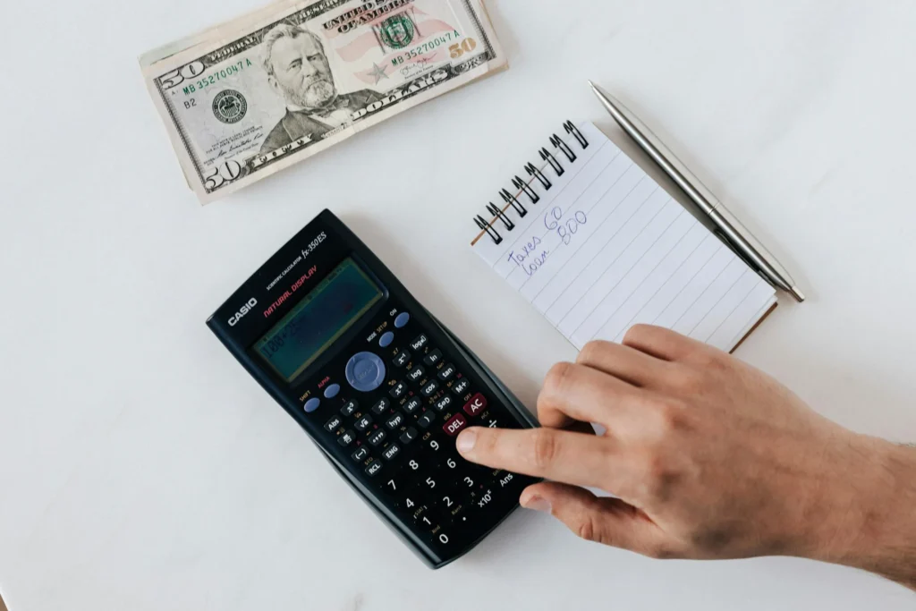 calculator, cash, and notepad - owner financing