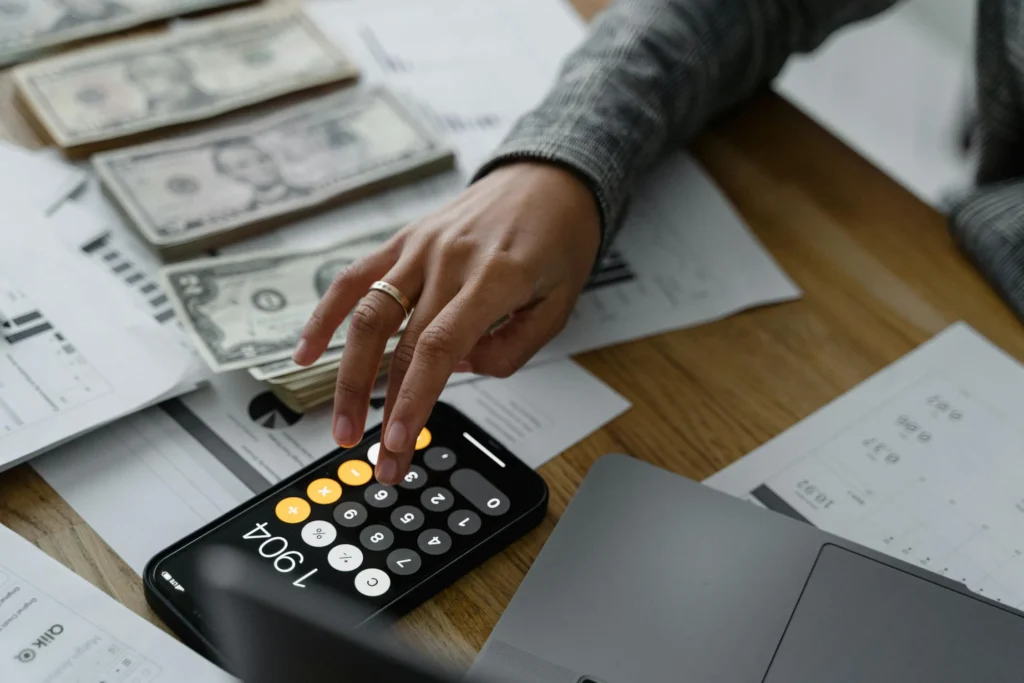 person calculating on phone - owner financed land texas