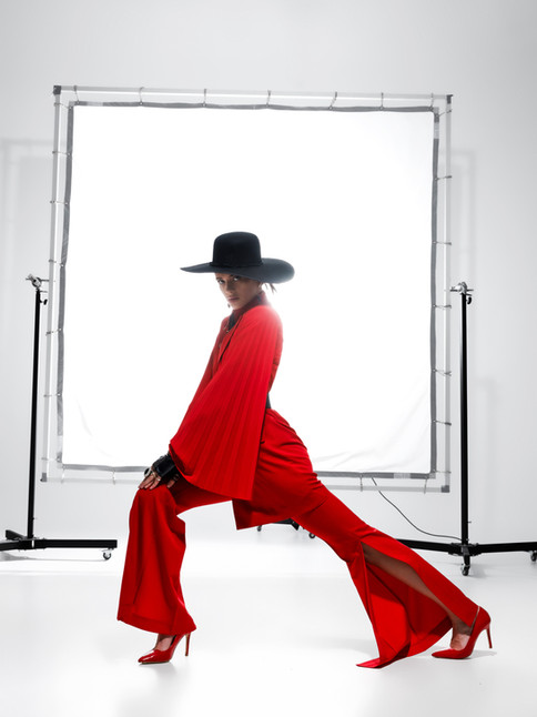 Full-length view of Eclair Flare Pants in black, showcasing the elegant flare and knee-high side slits on a model.