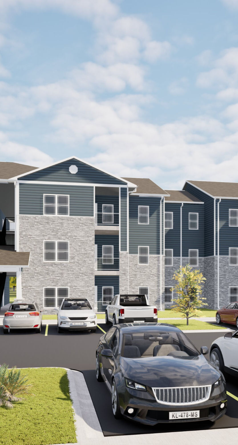 Modern apartment building with cars in the parking lot.