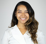 Picture of woman with dark hair wearing a white blouse