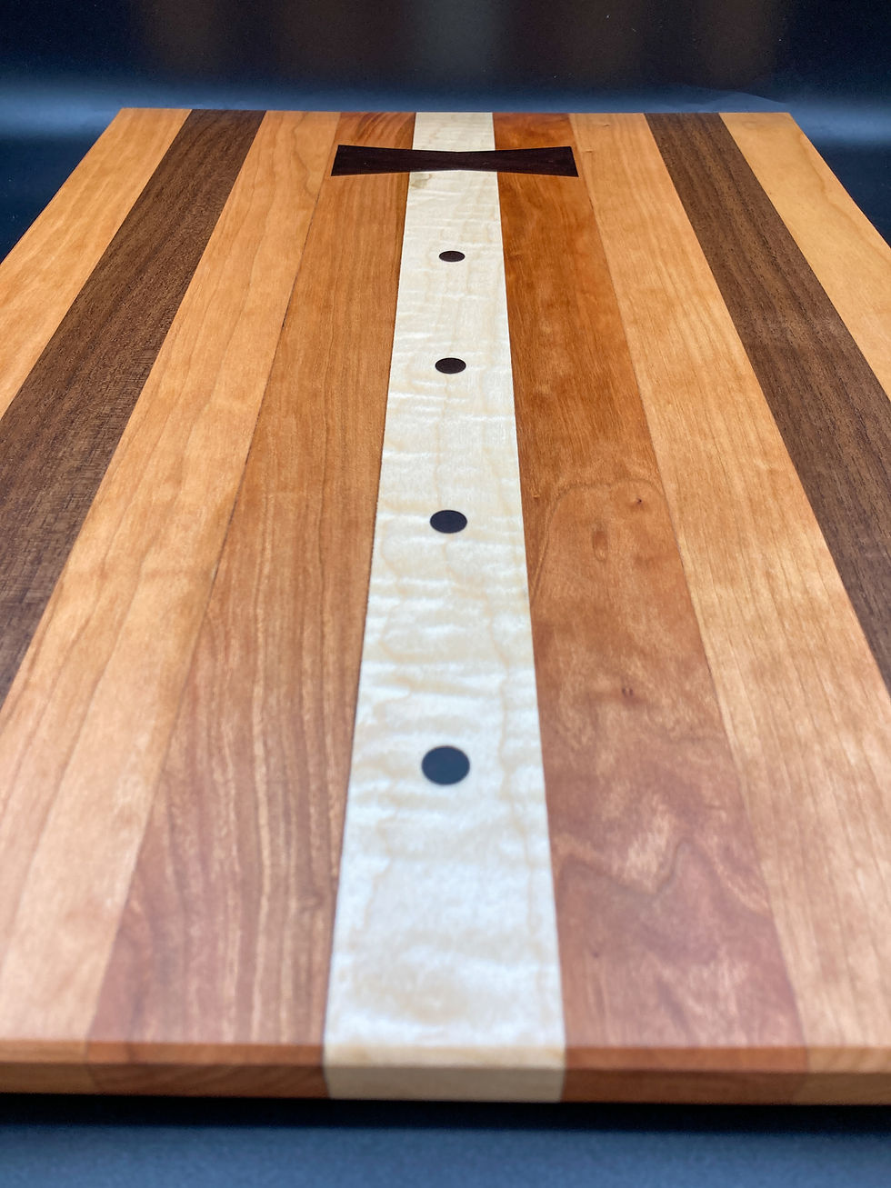 Thumbnail: Cherry / Black Walnut / Curly Maple Cutting Board with Ebony Bowtie and Buttons