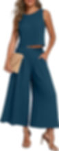Woman modeling a teal sleeveless crop top and wide-leg pants, holding a woven clutch for a chic Las Vegas Outfit.