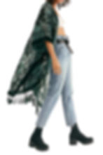 Side-view fashion model in a green patterned kimono, white top, light jeans, and black boots on a white background. Best day to night looks for Las Vegas.